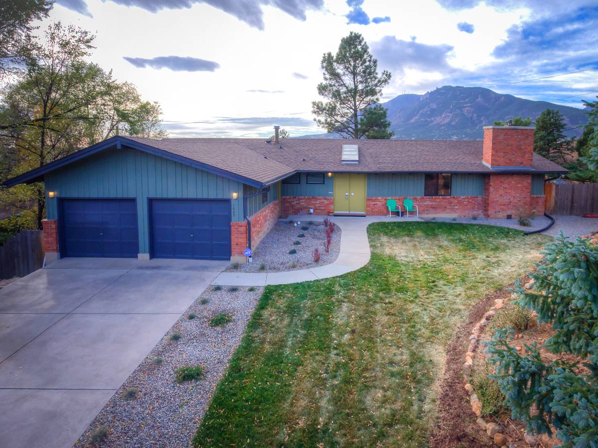Bright modern luxury living room with floor-to-ceiling windows and neutral tones in Colorado Springs | Top Tier Real Estate