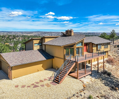 Single-story ranch home with xeriscape rock front yard and attached two-car garage in Colorado Springs | Top Tier Real Estate